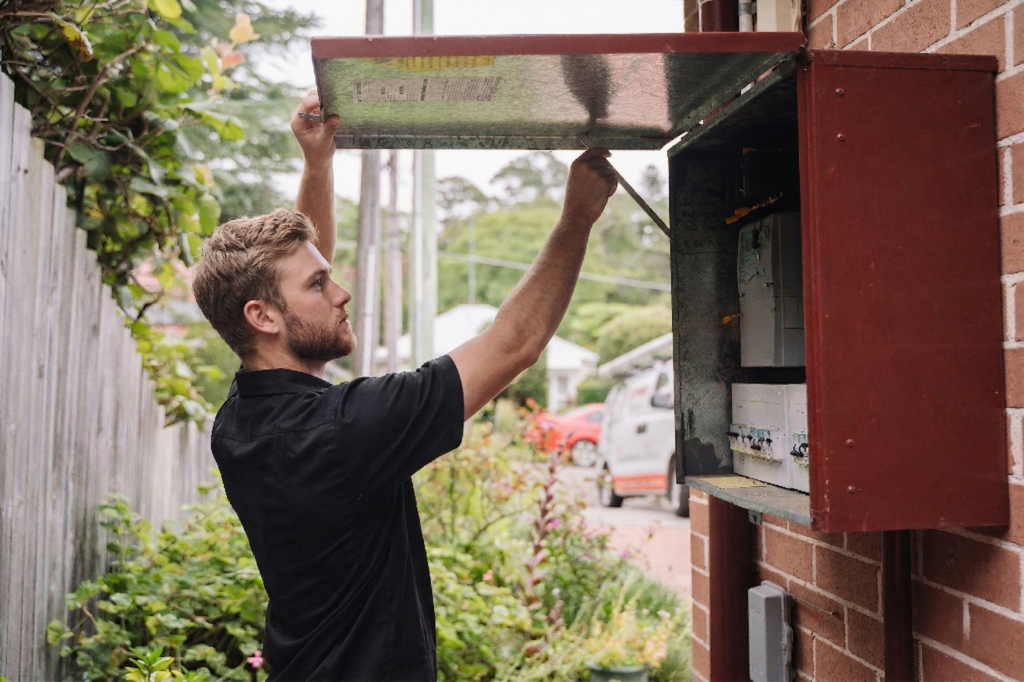 Electrician installing downlights in a Eastgardens home